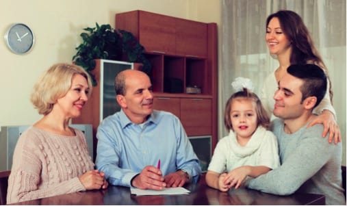 Family sitting at the table while grandparents draft a family trust