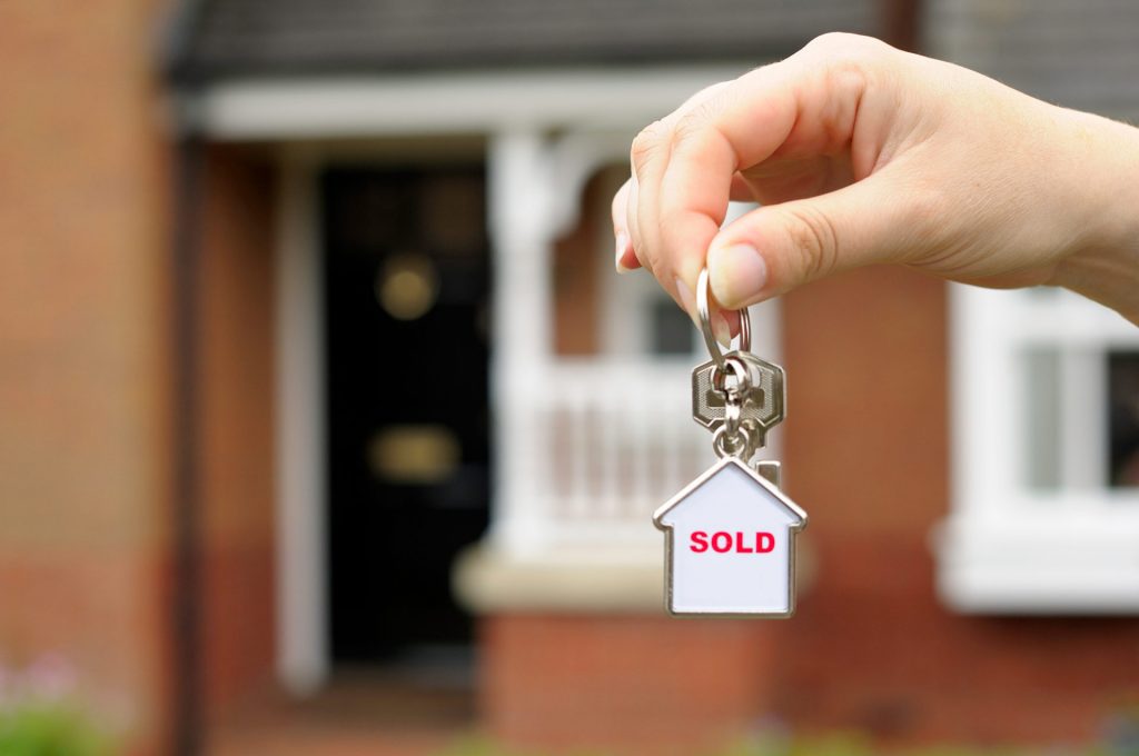 Keychain with key and house saying sold